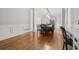 Bright dining room features hardwood floors, elegant trim, and a long table perfect for entertaining guests at 1109 Wiley Bridge Rd, Woodstock, GA 30188