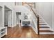 Bright foyer featuring hardwood floors, a staircase, and a console table at 1109 Wiley Bridge Rd, Woodstock, GA 30188