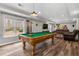 Open game room featuring a pool table, TV, seating and hardwood floors at 1109 Wiley Bridge Rd, Woodstock, GA 30188