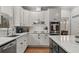 Modern kitchen featuring white cabinets, granite countertops, and stainless steel appliances at 1109 Wiley Bridge Rd, Woodstock, GA 30188