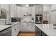 Modern kitchen featuring white cabinets, granite countertops, and stainless steel appliances at 1109 Wiley Bridge Rd, Woodstock, GA 30188