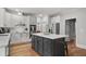 Spacious kitchen showcasing white cabinets, a center island, and modern appliances at 1109 Wiley Bridge Rd, Woodstock, GA 30188