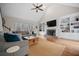 Inviting living room with vaulted ceilings, a fireplace, built-in shelving, and abundant natural light at 1109 Wiley Bridge Rd, Woodstock, GA 30188