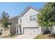 Two-story home with two-car garage and landscaping at 875 Venture Sw Way, Atlanta, GA 30331