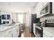 Modern kitchen with white cabinetry, stainless steel appliances, and quartz countertops at 875 Venture Sw Way, Atlanta, GA 30331