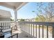 Relaxing covered porch with seating area overlooking a residential neighborhood at 875 Venture Sw Way, Atlanta, GA 30331