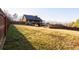 Large backyard featuring a spacious lawn, wooden fence, and a deck connected to the house at 116 Big Cotton Trl, Mcdonough, GA 30252