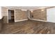 Spacious finished basement features stylish wood-look flooring and wood accent wall, adding warmth and character to the living space at 116 Big Cotton Trl, Mcdonough, GA 30252