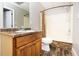 Bathroom features a shower and a stylish sink with warm wood cabinets and sleek fixtures, combining style and functionality at 116 Big Cotton Trl, Mcdonough, GA 30252