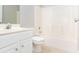 Clean bathroom featuring white vanity, toilet, and tiled shower-tub combination at 116 Big Cotton Trl, Mcdonough, GA 30252