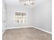 Spacious bedroom featuring neutral carpet and a bright window with views at 116 Big Cotton Trl, Mcdonough, GA 30252