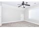 Bedroom features a ceiling fan, a window, neutral carpet, and an attic access door at 116 Big Cotton Trl, Mcdonough, GA 30252