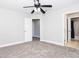 Spacious bedroom with a ceiling fan and two open doorways, and neutral carpet at 116 Big Cotton Trl, Mcdonough, GA 30252