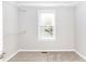 Empty walk-in closet with a window and built-in shelving for optimal storage at 116 Big Cotton Trl, Mcdonough, GA 30252