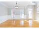 Inviting dining room featuring hardwood floors, wainscoting, and a large window at 116 Big Cotton Trl, Mcdonough, GA 30252