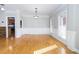 Bright dining room with hardwood floors, wainscoting, and view into adjacent kitchen at 116 Big Cotton Trl, Mcdonough, GA 30252