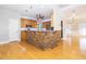 Stylish kitchen island with stone accents, granite countertops, and modern appliances at 116 Big Cotton Trl, Mcdonough, GA 30252