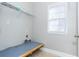 Functional laundry room with a built-in table, shelving and bright window at 116 Big Cotton Trl, Mcdonough, GA 30252