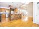 Open floor plan featuring a kitchen island, hardwood floors, and abundant natural light at 116 Big Cotton Trl, Mcdonough, GA 30252