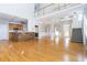 Open-concept living area with hardwood floors, staircase, and a modern kitchen at 116 Big Cotton Trl, Mcdonough, GA 30252