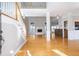 Spacious living room with gleaming hardwood floors, fireplace, and staircase to the second floor at 116 Big Cotton Trl, Mcdonough, GA 30252