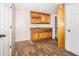 Basement wet bar area with warm wood cabinets and wood-look floors, perfect for entertaining Gathering and friends at 116 Big Cotton Trl, Mcdonough, GA 30252