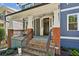 Inviting front porch with brick steps, metal railing, and a ceiling fan at 875 Berne Se St, Atlanta, GA 30316