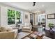 Bright living room with hardwood floors, comfy seating, and views of the entryway and dining area at 875 Berne Se St, Atlanta, GA 30316