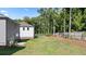 Landscaped backyard with privacy fence and trees at 1908 Holmsey Se Cir, Conyers, GA 30094