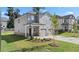 Two-story home with gray siding, two-car garage, and a landscaped front yard at 1908 Holmsey Se Cir, Conyers, GA 30094