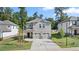 Two-story home with gray siding, two-car garage, and landscaped lawn at 1908 Holmsey Se Cir, Conyers, GA 30094