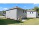 Rear view of gray house with backyard patio at 1908 Holmsey Se Cir, Conyers, GA 30094