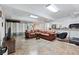 Finished basement recreation room with leather sofa, gym equipment, and tile flooring at 3355 Old Peachtree Rd, Dacula, GA 30019