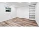 Simple basement room with wood flooring and built-in shelving at 3355 Old Peachtree Rd, Dacula, GA 30019