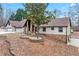 House exterior showcasing stone, wood, and a tree at 3355 Old Peachtree Rd, Dacula, GA 30019