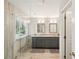 Bathroom featuring double vanity with gray cabinets, framed mirrors, and glass shower at 485 Kensington Parc Dr, Avondale Estates, GA 30002