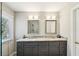 Modern bathroom featuring a double vanity with gray cabinets and elegant mirrors at 485 Kensington Parc Dr, Avondale Estates, GA 30002