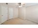 Bedroom with beige walls, ceiling fan and two white doors at 485 Kensington Parc Dr, Avondale Estates, GA 30002