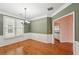 Charming dining room with wainscoting, hardwood floors, and elegant chandelier lighting at 485 Kensington Parc Dr, Avondale Estates, GA 30002