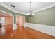 Dining area featuring hardwood floors, wainscoting and a modern light fixture at 485 Kensington Parc Dr, Avondale Estates, GA 30002