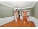 Open dining area featuring hardwood floors, wainscoting and modern light fixture at 485 Kensington Parc Dr, Avondale Estates, GA 30002