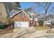 Two-story brick home with garage and driveway, featuring manicured front lawn at 485 Kensington Parc Dr, Avondale Estates, GA 30002