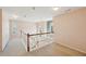 Upstairs hallway with a view of arched windows, and a wood and white railing at 485 Kensington Parc Dr, Avondale Estates, GA 30002