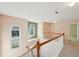 The upstairs hallway features carpeting and a wooden railing with white balusters at 485 Kensington Parc Dr, Avondale Estates, GA 30002