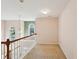 Upstairs carpeted hallway with a wood and white railing and arch-top windows at 485 Kensington Parc Dr, Avondale Estates, GA 30002