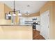 An eat in kitchen features white cabinets and a breakfast bar with dark countertop at 485 Kensington Parc Dr, Avondale Estates, GA 30002