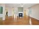 Open-concept living room with hardwood floors and cozy fireplace at 485 Kensington Parc Dr, Avondale Estates, GA 30002