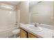 Bathroom featuring a bath-shower combo, sink, and neutral-toned walls at 4671 W Lake Se Dr, Conyers, GA 30094