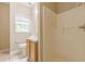 Cozy bathroom featuring a window, toilet, and vanity with wood cabinetry at 4671 W Lake Se Dr, Conyers, GA 30094