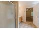 Bathroom area with wooden cabinets, tiled flooring, and a partial view of the shower at 4671 W Lake Se Dr, Conyers, GA 30094